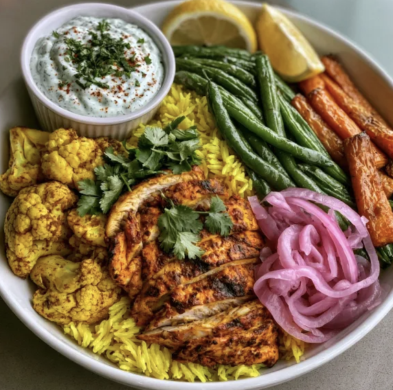 For Pros: Golden Anti-Inflammatory Bowl with Tandoori Chicken, Turmeric Basmati Rice, Spiced Cauliflower, Sautéed Green Beans, Carrots, Pickled Red Onion, Cilantro, Lemon, Mint Yogurt Sauce