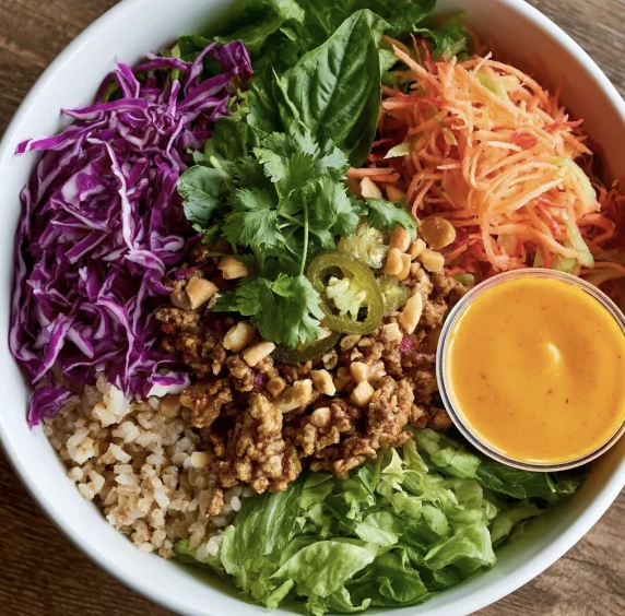 For Pros: Bangkok Larb Bowl with Thai Turkey, Brown Rice, Shredded Romaine, Shredded Cabbage, Shredded Carrot, Shredded Papaya, Basil, Cilantro, Peanuts, Pickled Jalapeño, Thai Carrot Lime Dressing