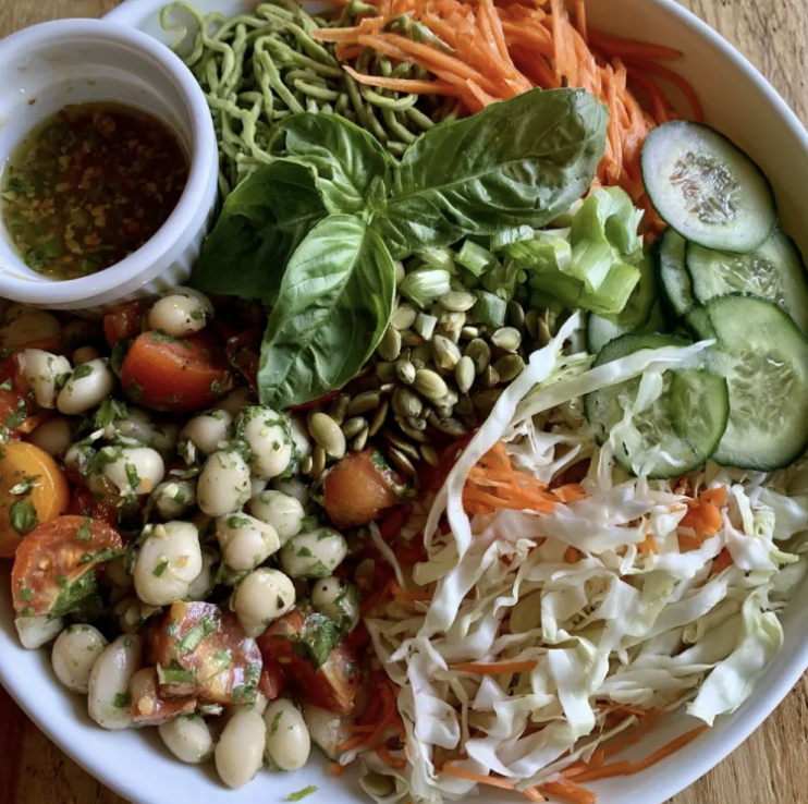 Thai Crunch Salad with White Bean Tomato Herb Salad, Edamame Noodles, Shredded Napa Cabbage, Shredded Carrots, Sliced Persian Cucumber, Thai Basil, Scallions, Pepitas, Lemongrass Ginger Dressing