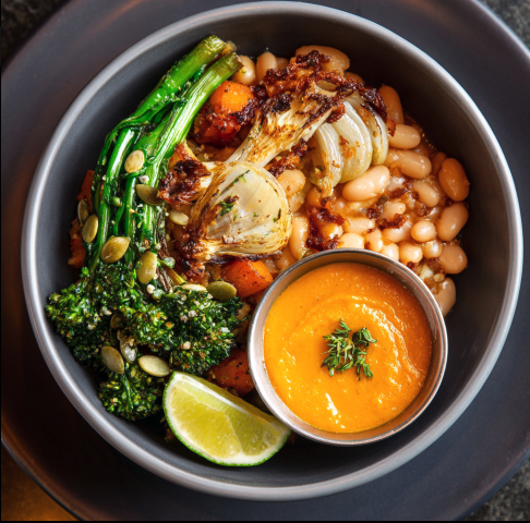 Vegan Comfort Soup Bowl with White Beans, Roasted Butternut Squash, Roasted Onion, Caramelized Fennel, Broccolini, Pepitas, Lime with Roasted Carrot & Thyme Purée
