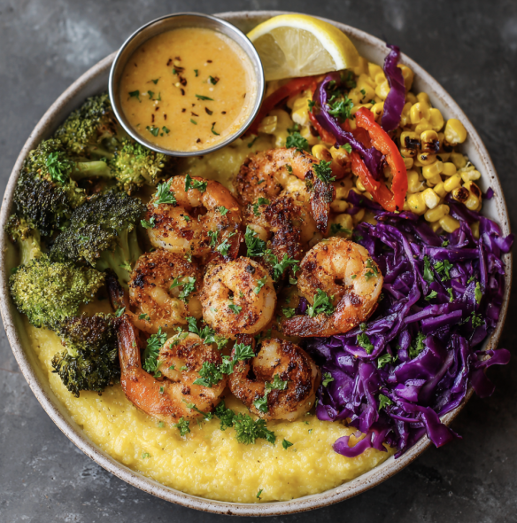 For Pros: Bayou Power Bowl with Cajun Shrimp, Polenta, Bell Peppers, Broccoli, Roasted Corn, Shredded Red Cabbage, Parsley, Lemon Wedge, Sauteed Garlic, Citrus Cajun Drizzle