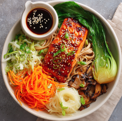 For Pros: Umami Balance Bowl with Miso-Glazed Salmon, Brown Rice Noodles, Bok Choy, Carrots, Napa Cabbage, Shiitake Mushrooms, Scallions, Sesame Seeds, Sesame-Lime Drizzle