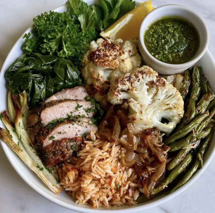 Garden Chimichurri Bowl with Herb Roasted Pork Tenderloin, Tomato Garlic Basmati Rice, Cauliflower, Caramelized Onions, Collard Green, Fennel, Green Bean, Parsley, Lemon, Chimichurri Sauce