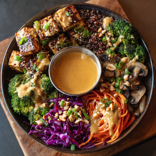 Sesame Peanut Bowl with Smoky Peanut Tofu, Red Quinoa, Mushrooms, Broccoli, Sesame Carrot and Red Cabbage Slaw, Peanuts, Scallions, Chili Lime Peanut Sauce