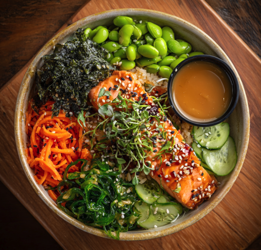 For Pros: Poke Bowl with Miso Salmon, Brown Rice, Shredded Carrots, Cucumber, Edamame, Nori, Sesame Seeds, Fresh Ginger, Seaweed Salad, Sesame Miso Dressing