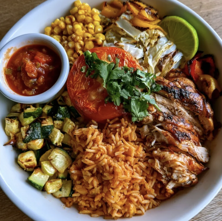 For Pros: Smoky Chipotle Bowl with Chicken Tinga, Tomato Garlic Basmati Rice, Zucchini, Cabbage, Tomato, Charred Corn, Roasted Bell Pepper, Cilantro, Lime Wedge, Salsa Roja