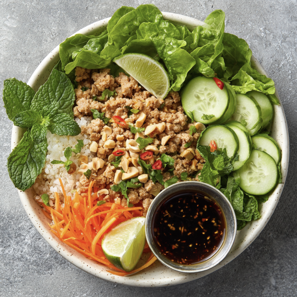 Bangkok Larb Bowl with Ground Turkey with Lettuce, Cucumber, Carrots, Daikon, Quinoa, Lime, Mint, Basil, Cilantro, Scallion, Sesame Seed, Peanut, Slivered Onion, Lemongrass Tamari Dressing