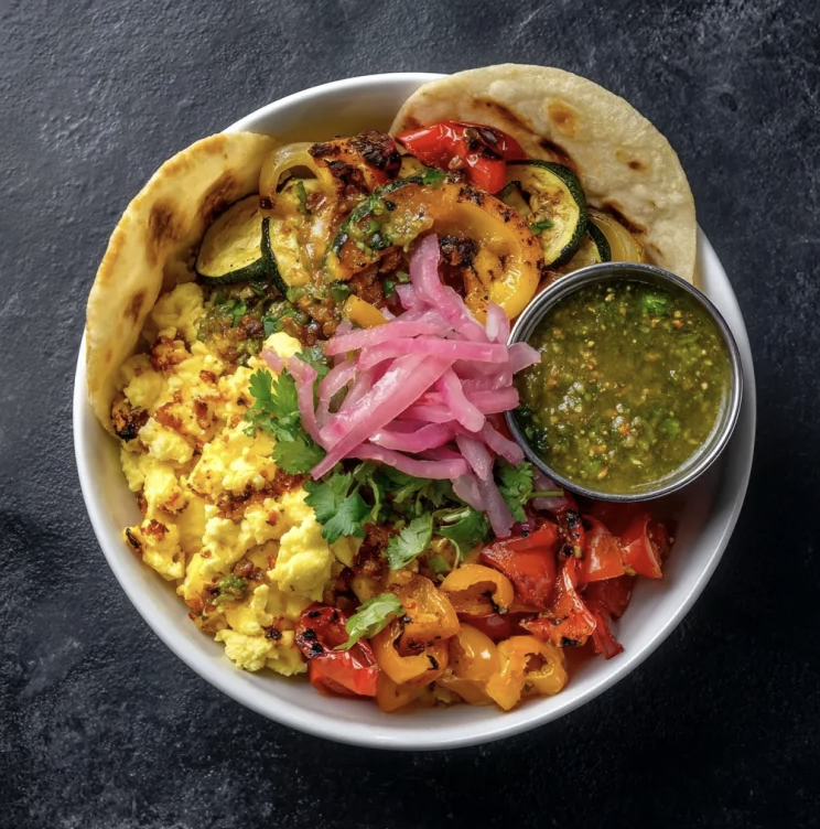 Southwest Breakfast Taco Bowl with Scrambled Eggs, Corn Tortilla, Peppers, Zucchini, Tomatoes, Pickled Onion, Cilantro, Salsa Verde