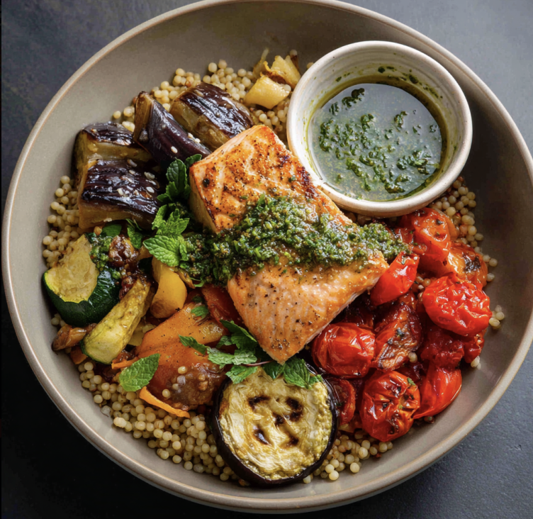 Maghreb Glow Bowl with Chermoula Salmon, Sorghum, Tomatoes, Roasted Zucchini, Roasted Red Pepper, Roasted Eggplant, Preserved Lemon, Parsley, Mint, Chermoula Sauce