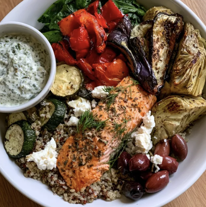 For Pros: Santorini Nourish Bowl with Greek Salmon, Quinoa, Roasted Zucchini, Spinach, Red Peppers, Eggplant, Artichokes, Feta, Dill, Olives, Dried Oregano, Greek Lemon Herb Sauce