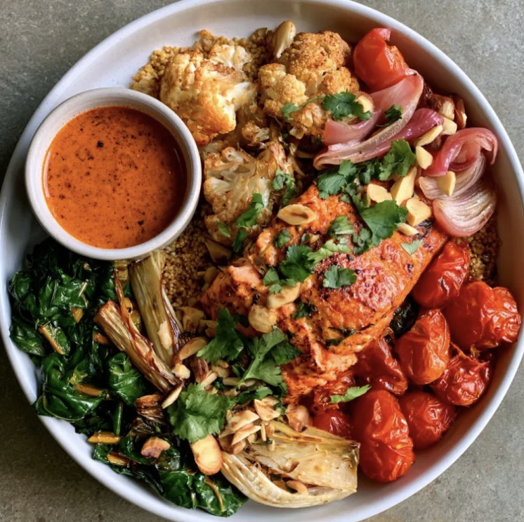 Casablanca Bowl with Smoky Red Pepper Salmon, Amaranth, Tomatoes, Cauliflower, Green Beans, Cilantro, Almonds, Pickled Shallots, Roasted Red Pepper Chermoula Sauce