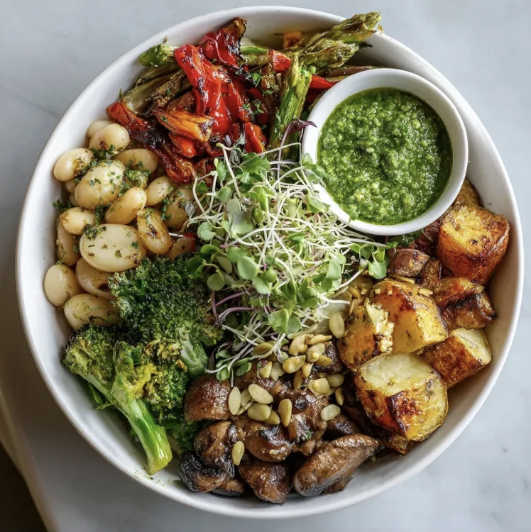 Garden Pesto Bowl with White Beans, Lemony Roasted Potatoes, Broccoli, Mushrooms, Asparagus, Peppers, Sunflower Seeds, Microgreens, Parmesan, Basil Arugula Pesto