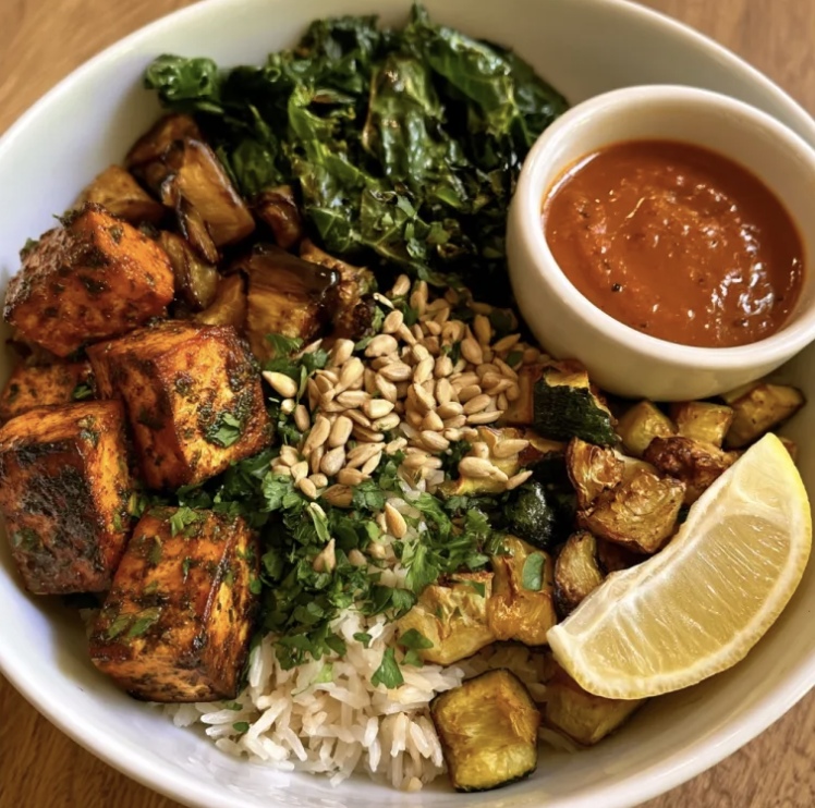 Charred Pepper Bowl with Smoky Herb Tofu, Basmati Rice, Roasted Eggplant, Steamed Kale, Roasted Zucchini, Parsley, Sunflower Seeds, Lemon Wedge, Smoky Red Pepper Sauce