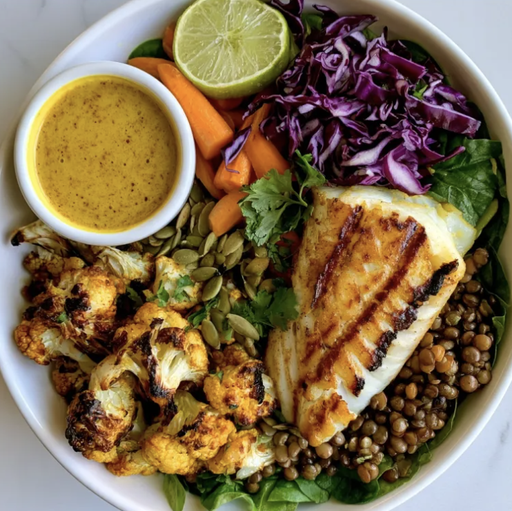 For Pros: Tropical Nourish Bowl with Curry Cod, Lentils, Curry Roasted Cauliflower, Carrots, Red Cabbage, Spinach, Cilantro, Pumpkin Seeds, Lime, Coconut Curry Sauce