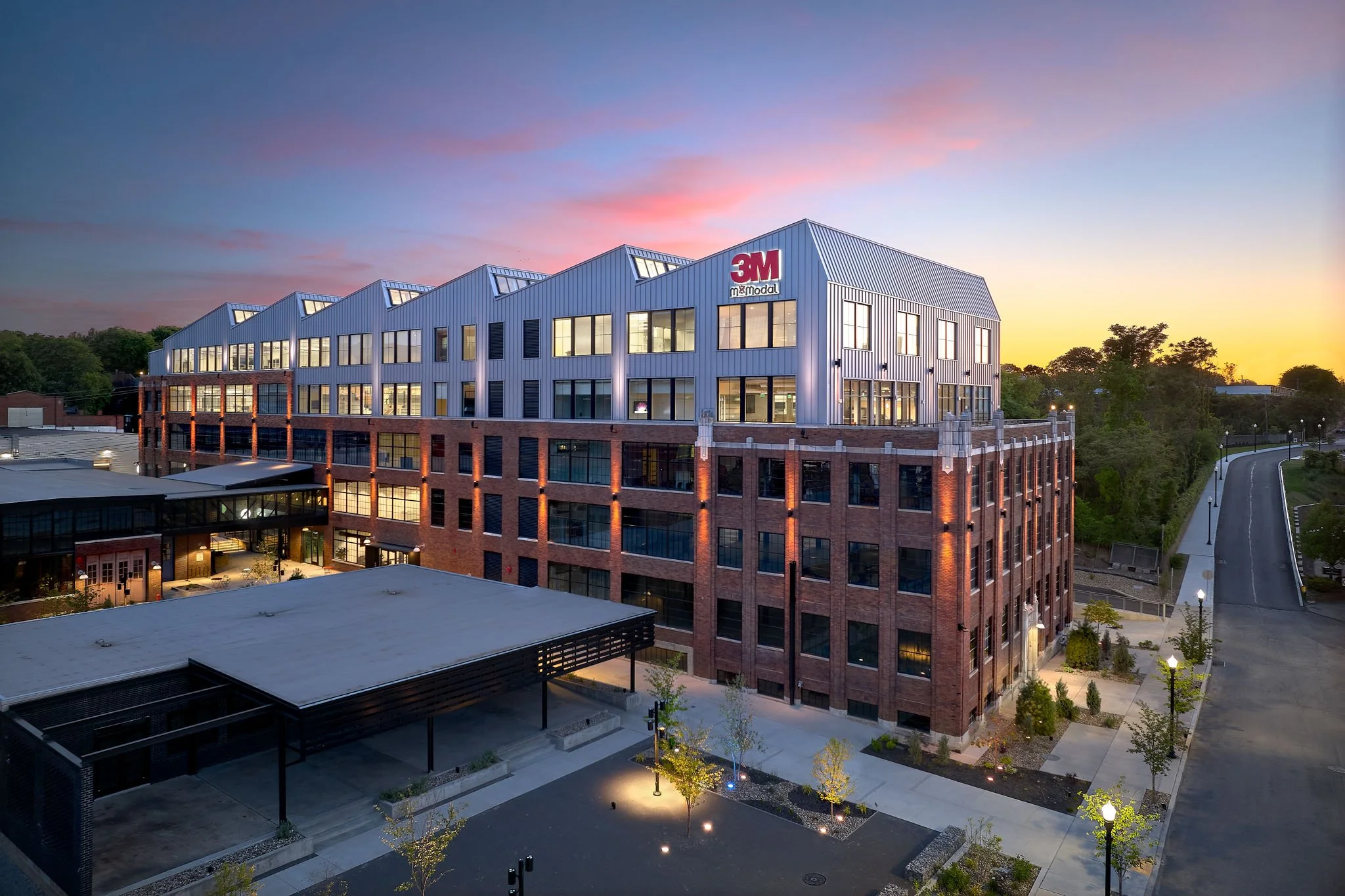 Aerial view of a commercial industrial complex with multiple buildings and large parking lots.
