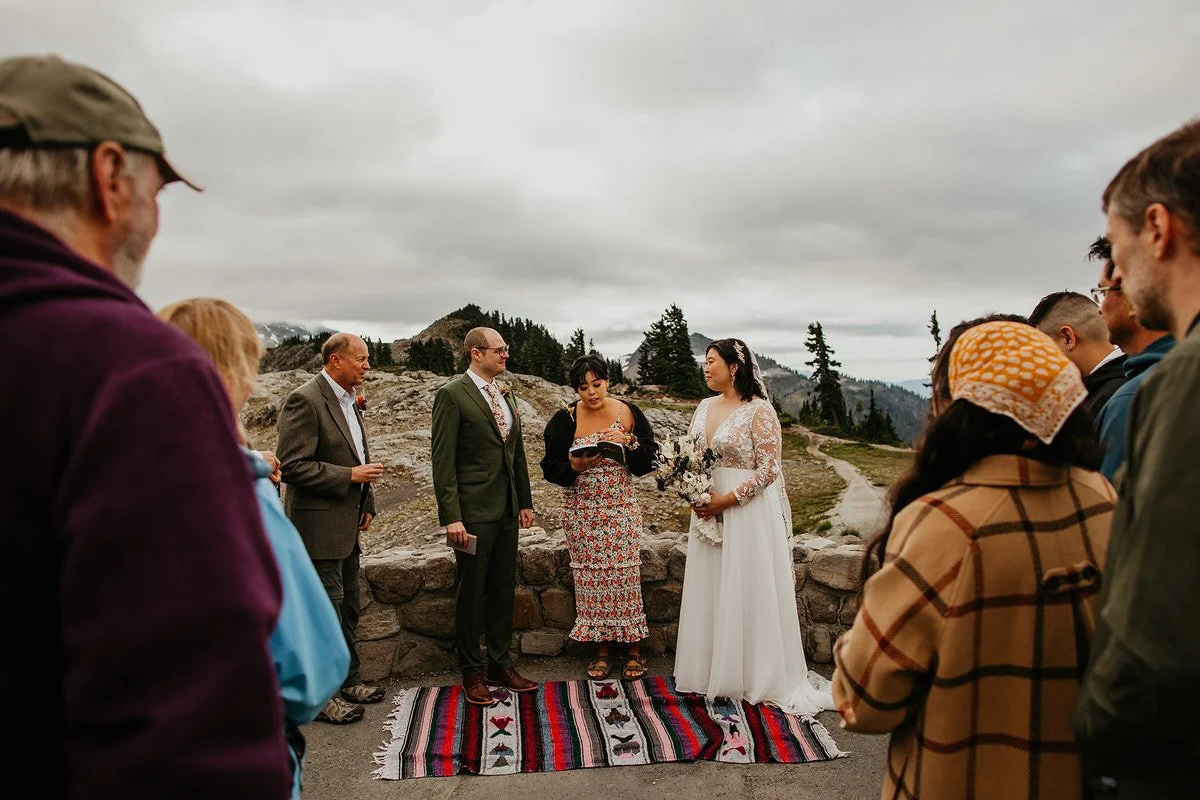 Small elopement ceremony with guests gathered at a scenic mountain viewpoint in Washington