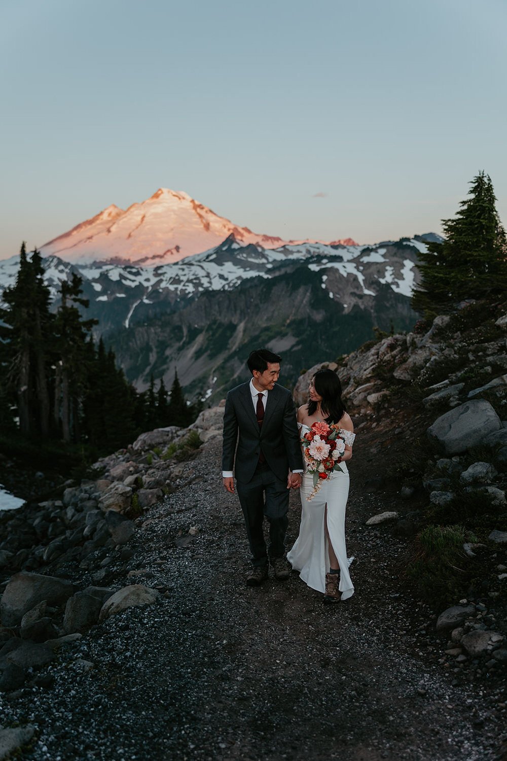 Alpine terrain in Washington during summer with wildflowers, clear skies, and expansive mountain views