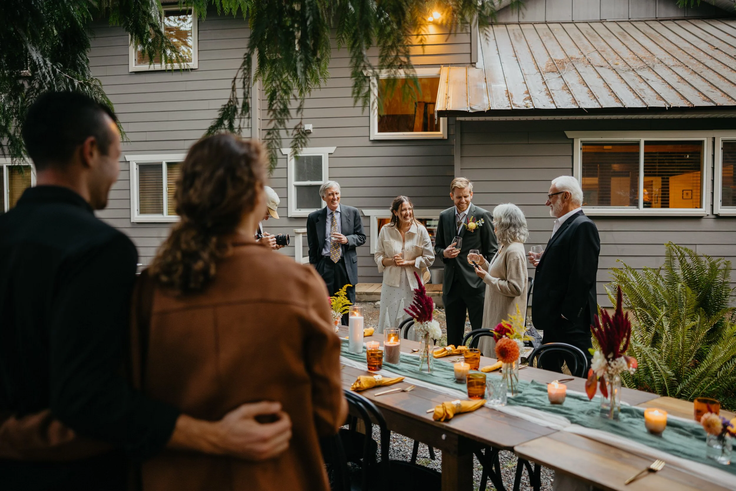Family gathered around a long table during a private Airbnb elopement reception
