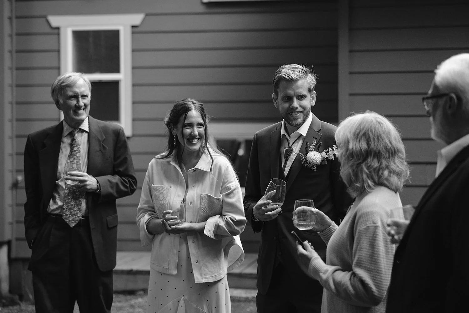 Couple and guests laughing together during an outdoor elopement reception