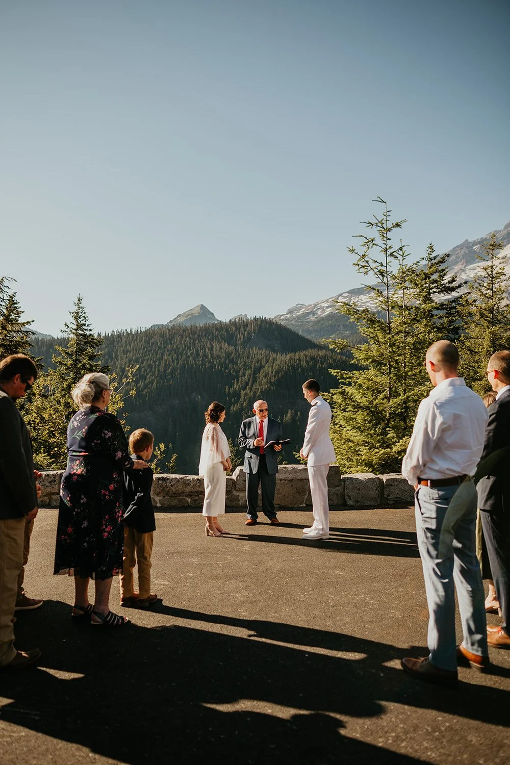 Elopement ceremony at a mountain viewpoint with guests gathered around the couple in Washington
