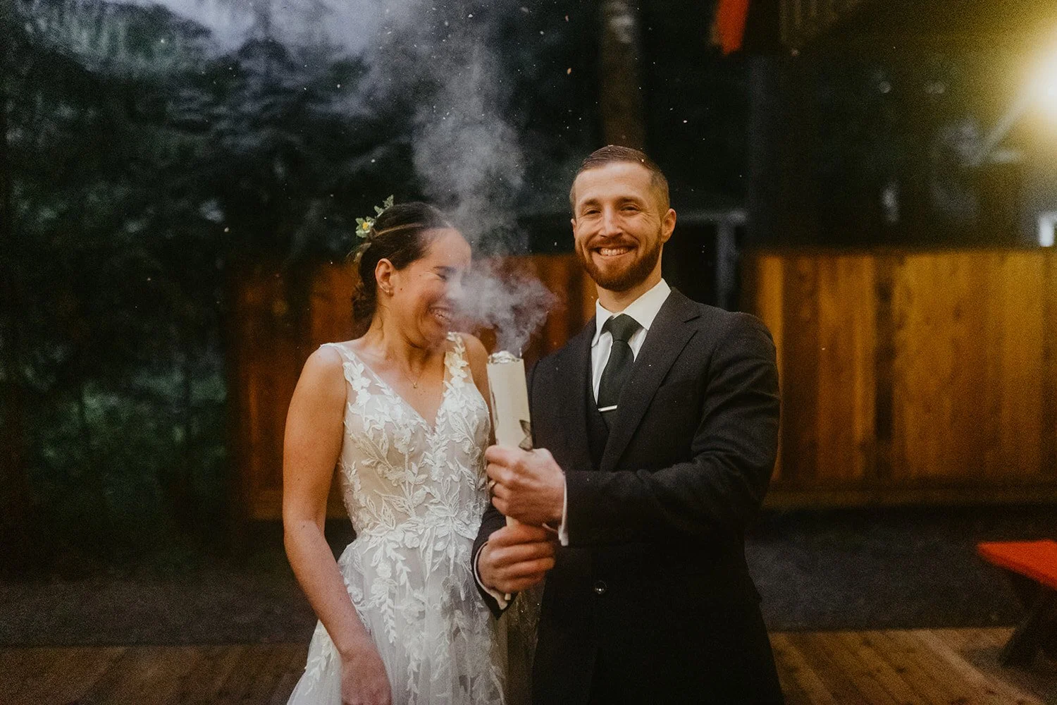Groom and Bride reacting to a white confetti popper on a cabin deck