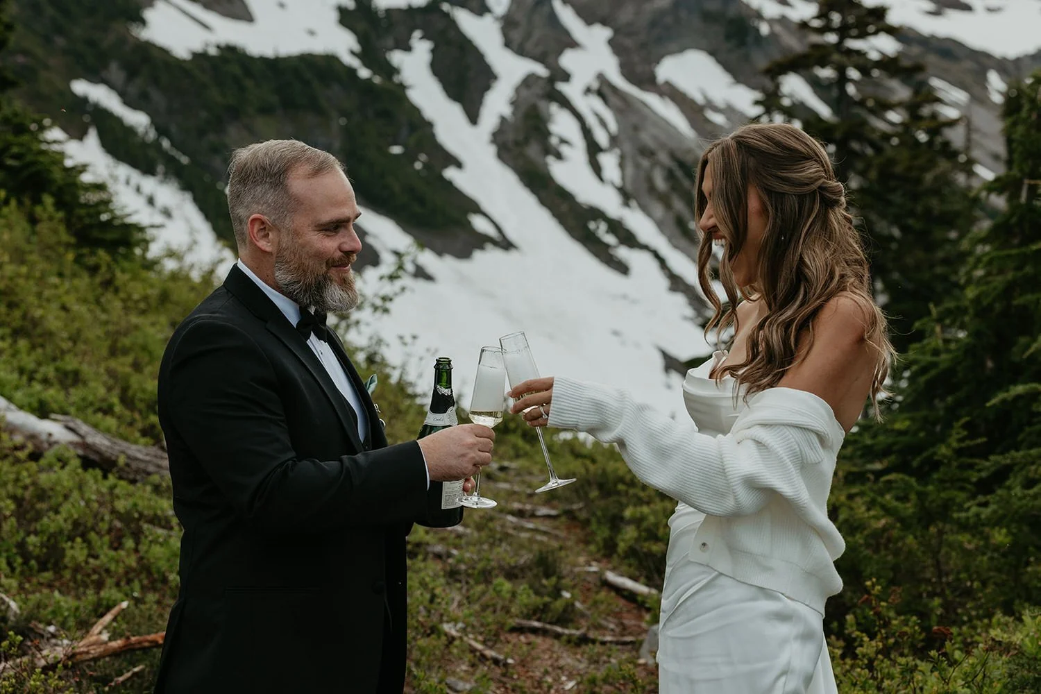 Eloping couple celebrating with champagne in a snowy alpine setting art Artist Point