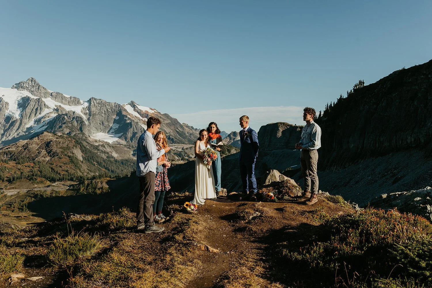 Elopement ceremony on a mountain ridge with small group of guests and alpine views in Washington