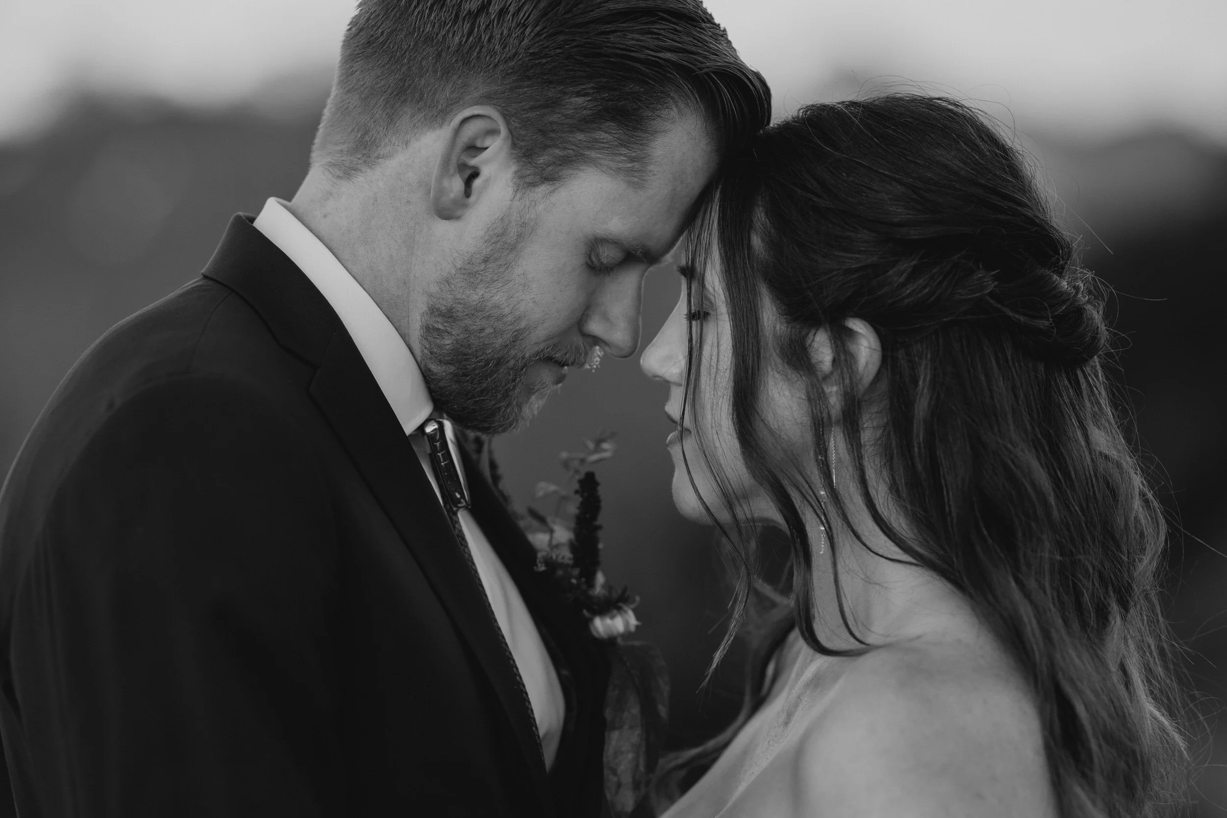 Close-up portrait of a couple touching foreheads during an intimate mountain elopement