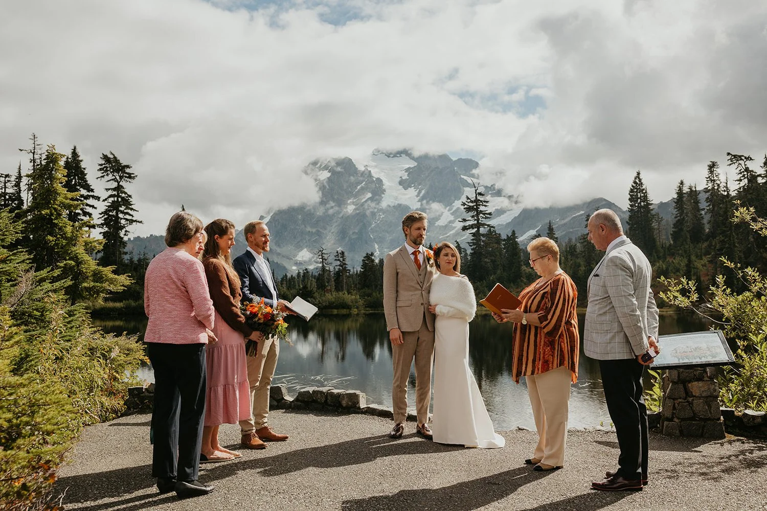 Elopement ceremony with guests beside an alpine lake in the North Cascades with mountain views
