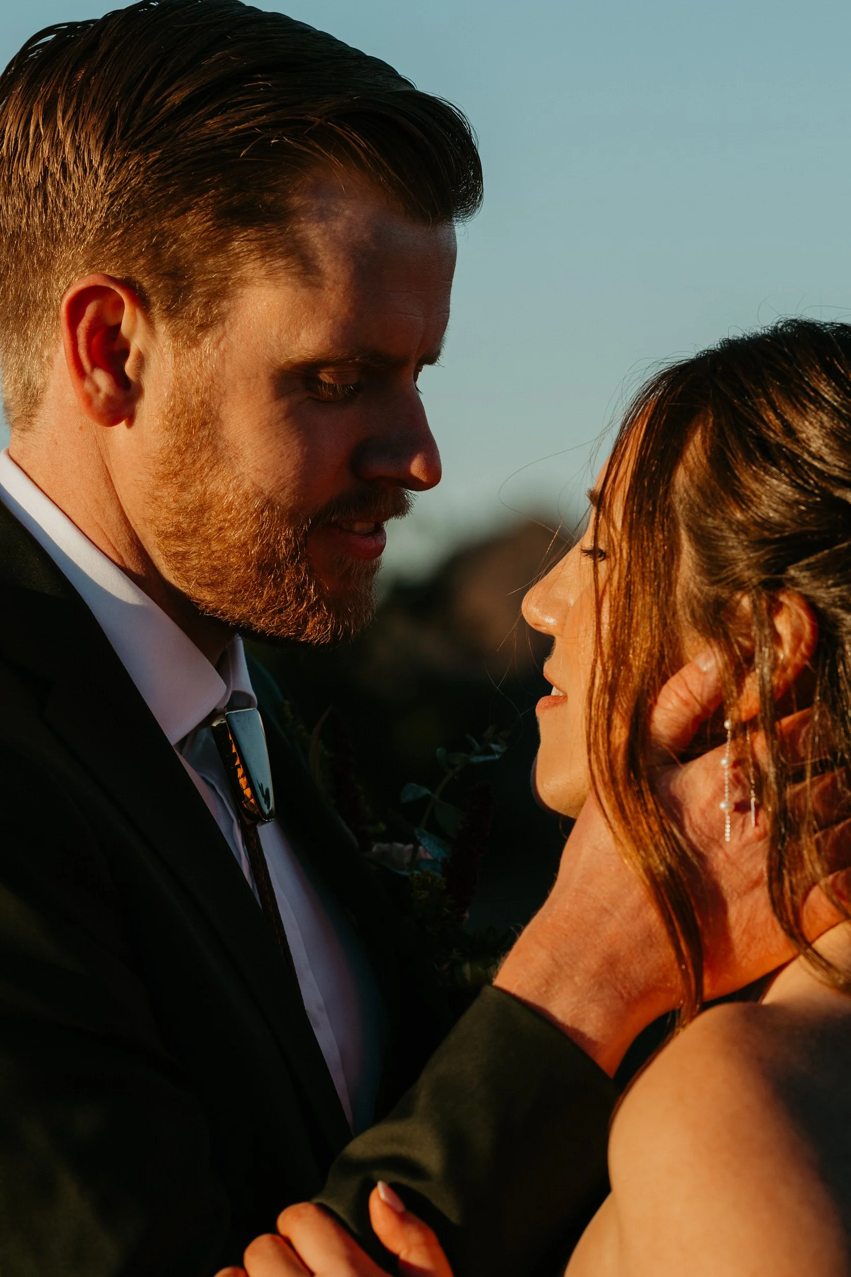 Close-up of a couple sharing an emotional moment during sunrise elopement portraits