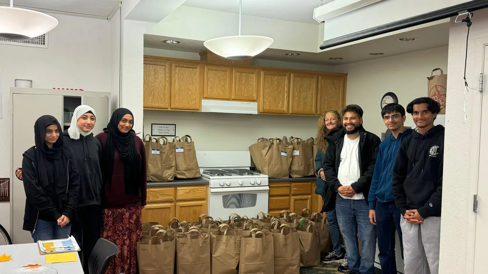 Salaam Food Pantry volunteers in a kitchen with packed goods for families