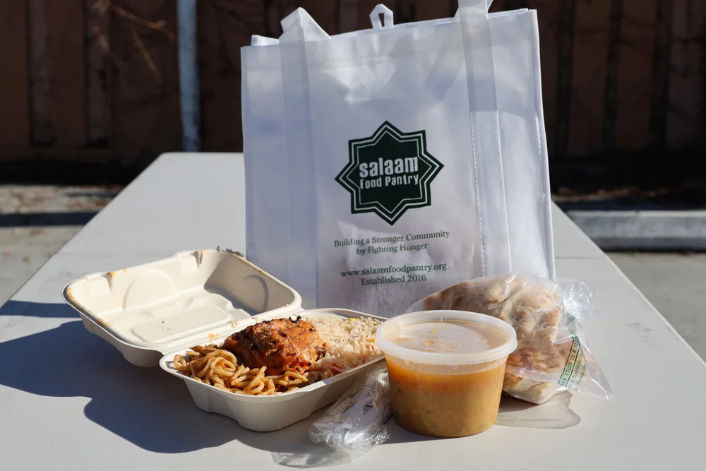 A hot meal packed in a Salaam Food Pantry bag
