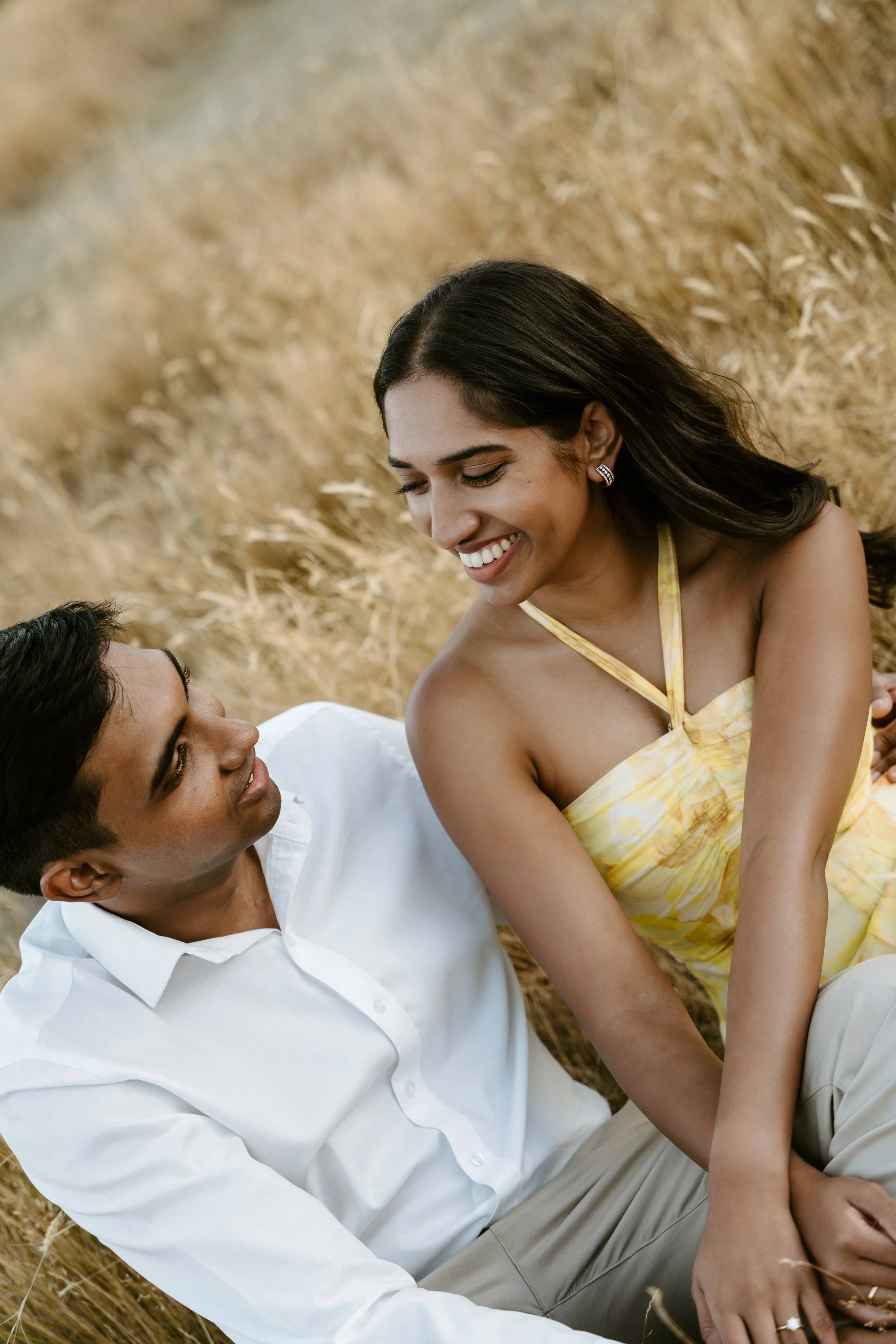 couple smiling at eachother during prposal shoot in wanaka