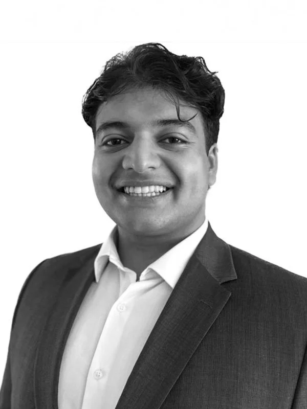 Greyscale portrait photo of Omar Khan