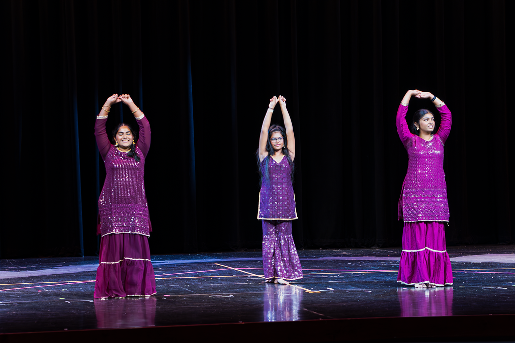 Teen dancers showcasing synchronized choreography at a spring dance recital performance