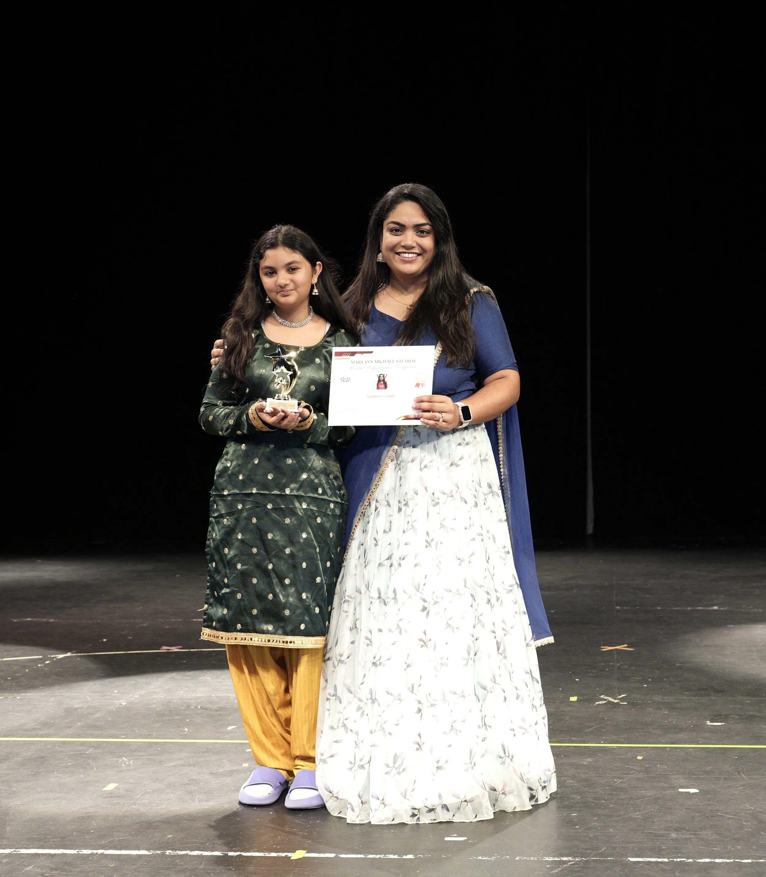 Adult holds her Certificate of Completion from their Summer Recital Performance
