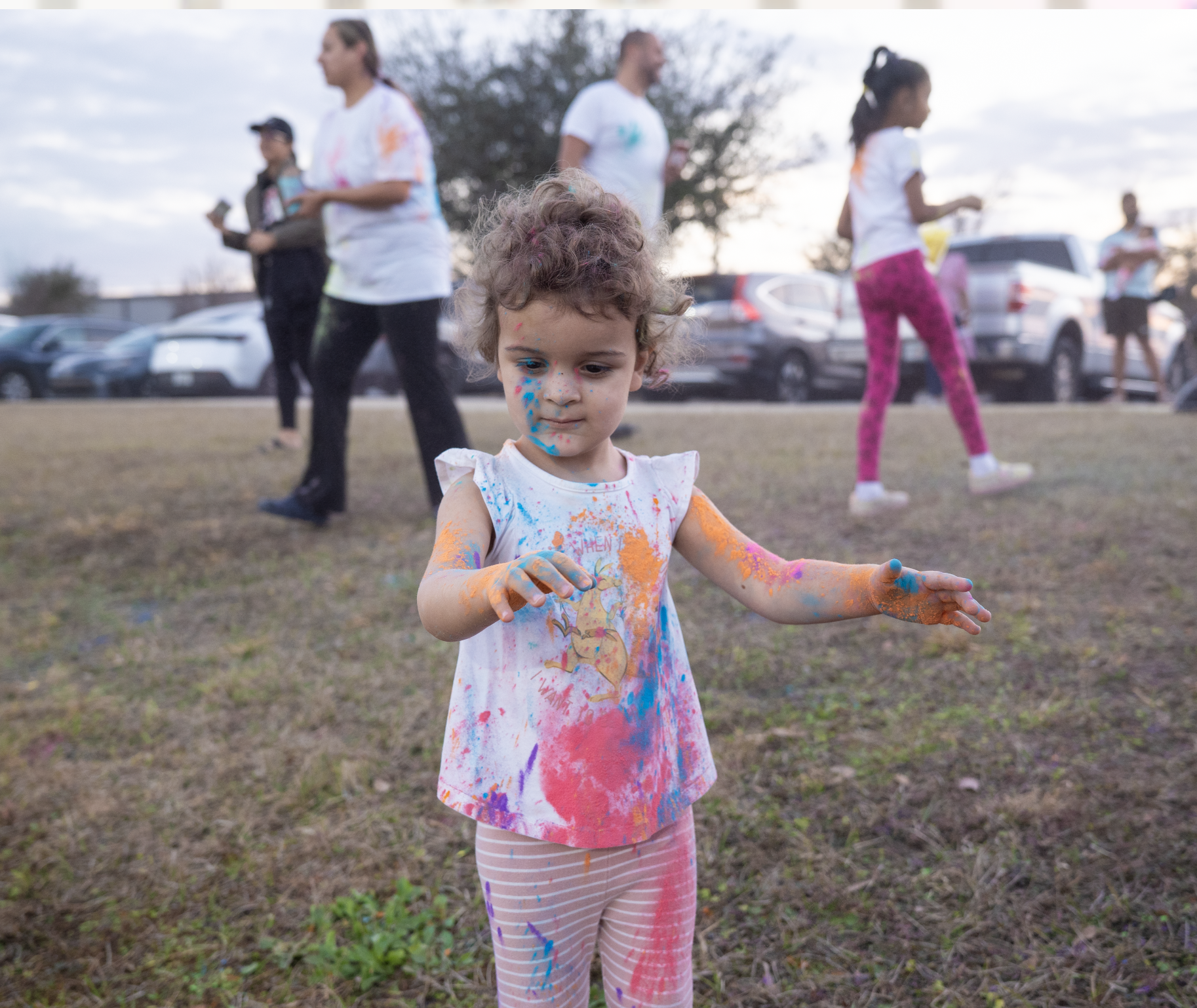 a kid in colorful holi powder shirt