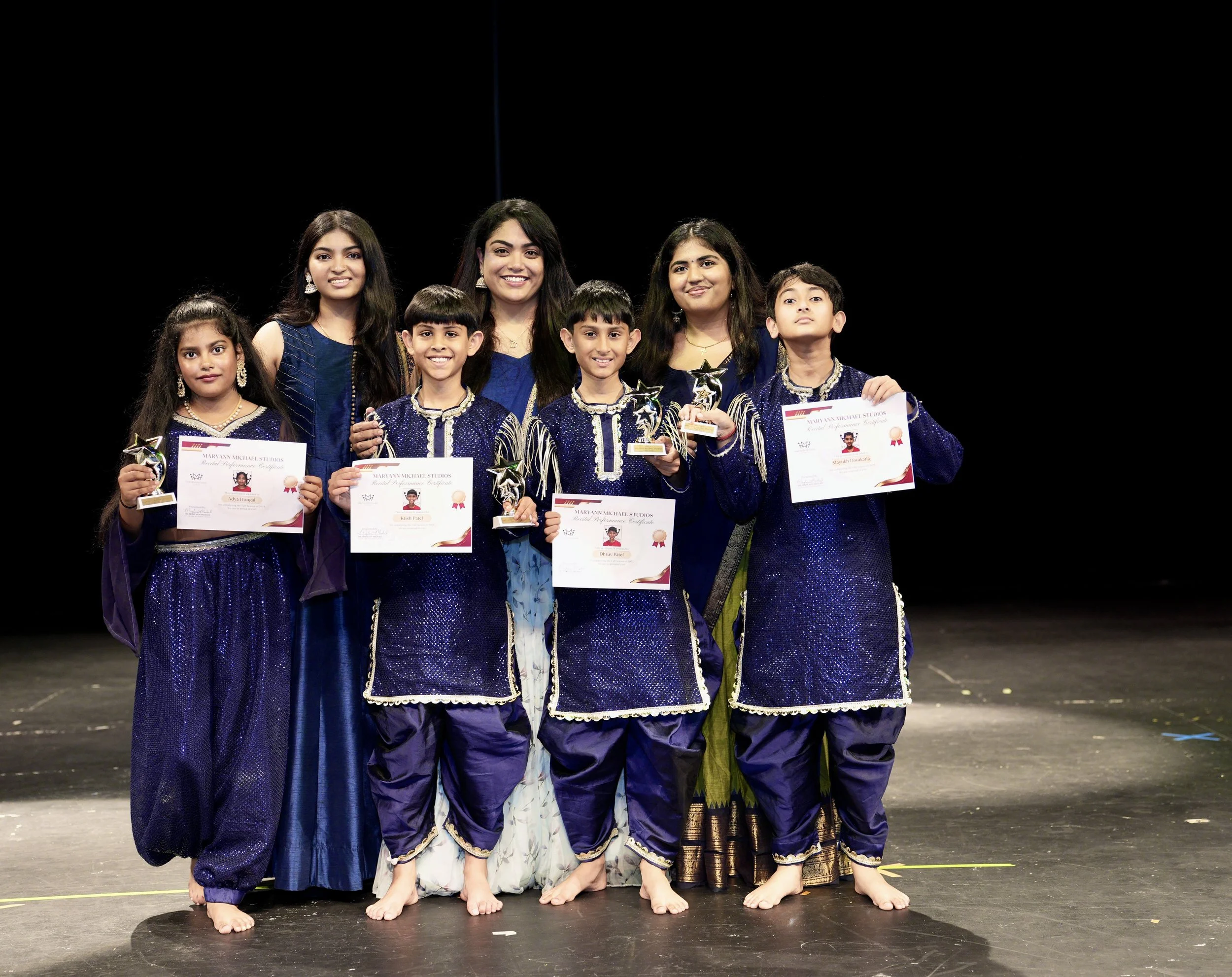 Teens performing a Bollywood dance routine on stage during the Fall Recital