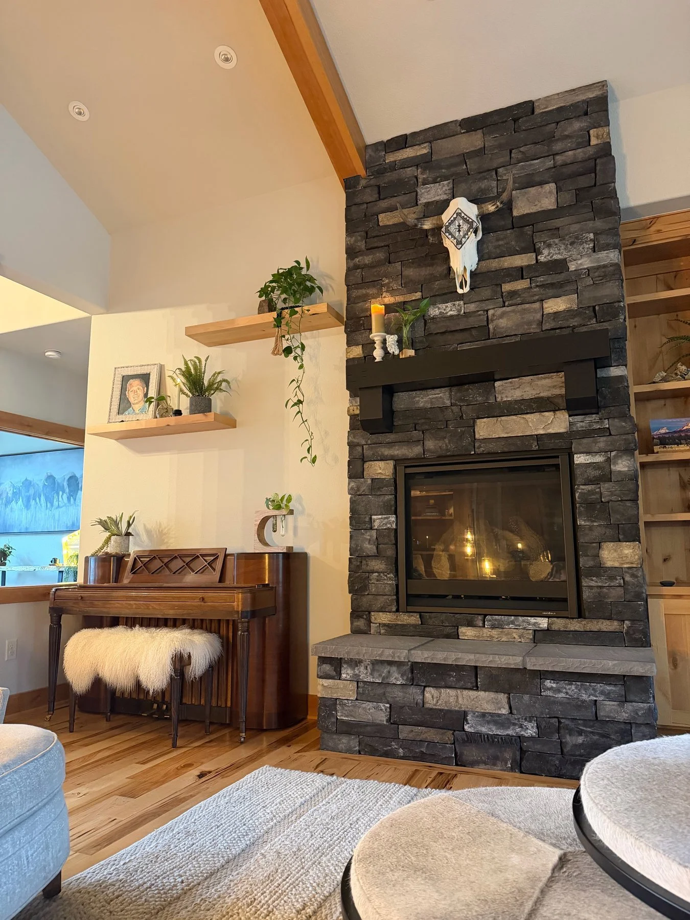 Stone fireplace and black mantel in an Eaglecrest living room after interior painting in Central Oregon