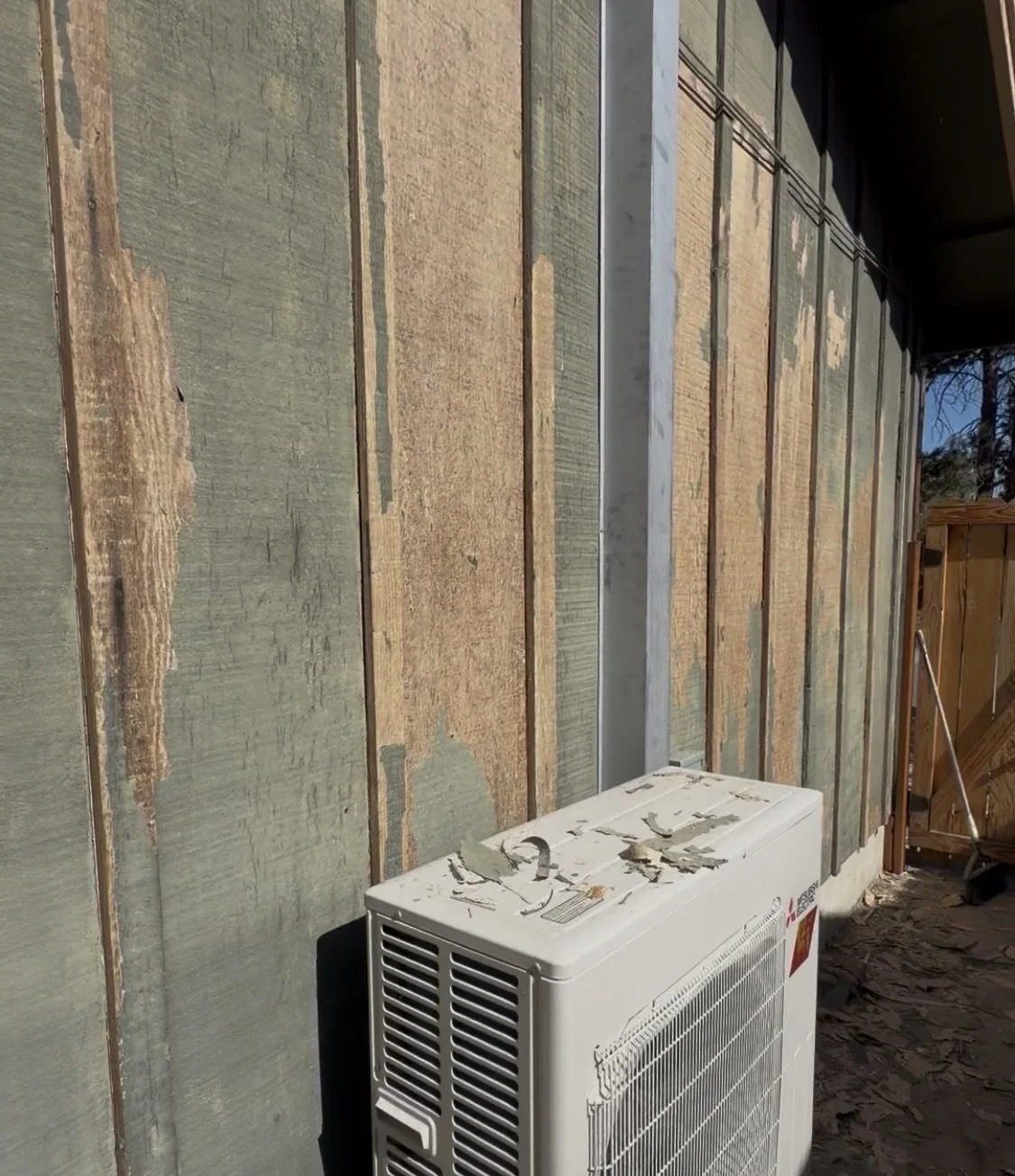 Board-and-batten wall scraped down to bare wood before exterior painting in Bend, Oregon