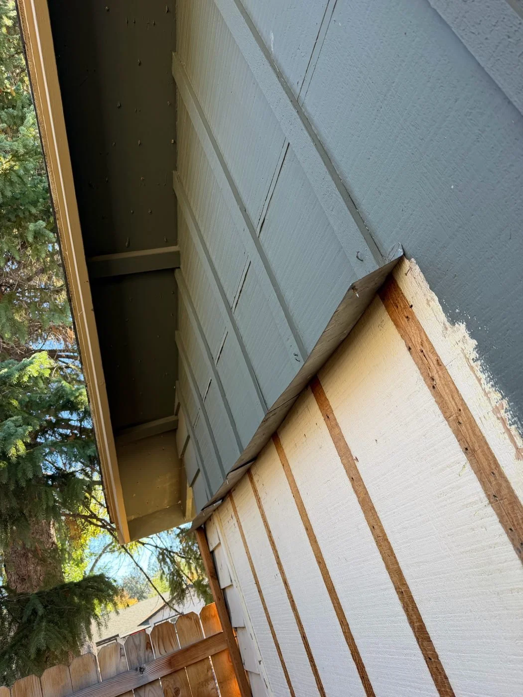 bend-siding-repair-new-boards-primed-eave.jpg