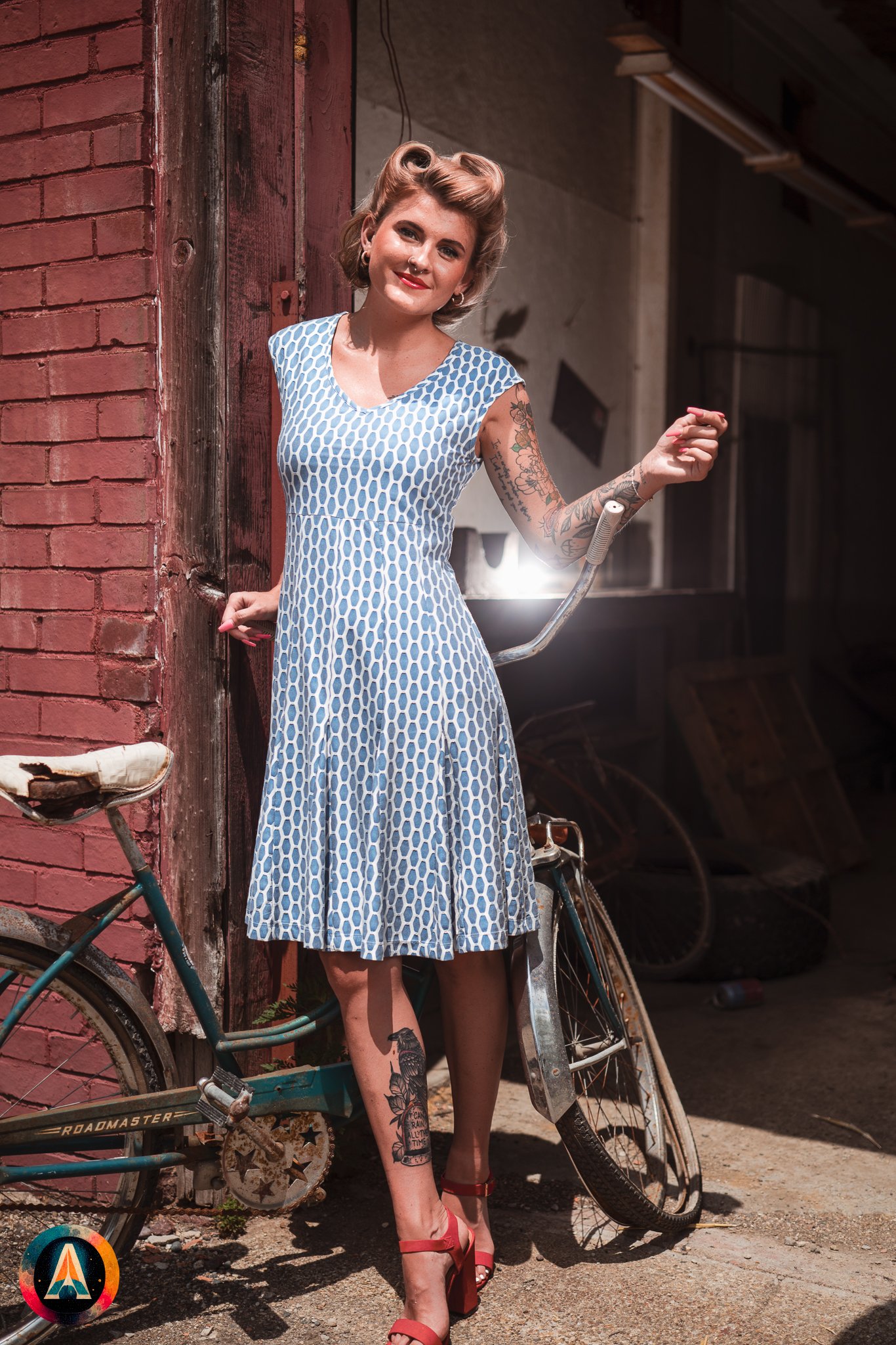 Blonde model courtney france poses in an abandoned shop / laundromat in pinup attire.