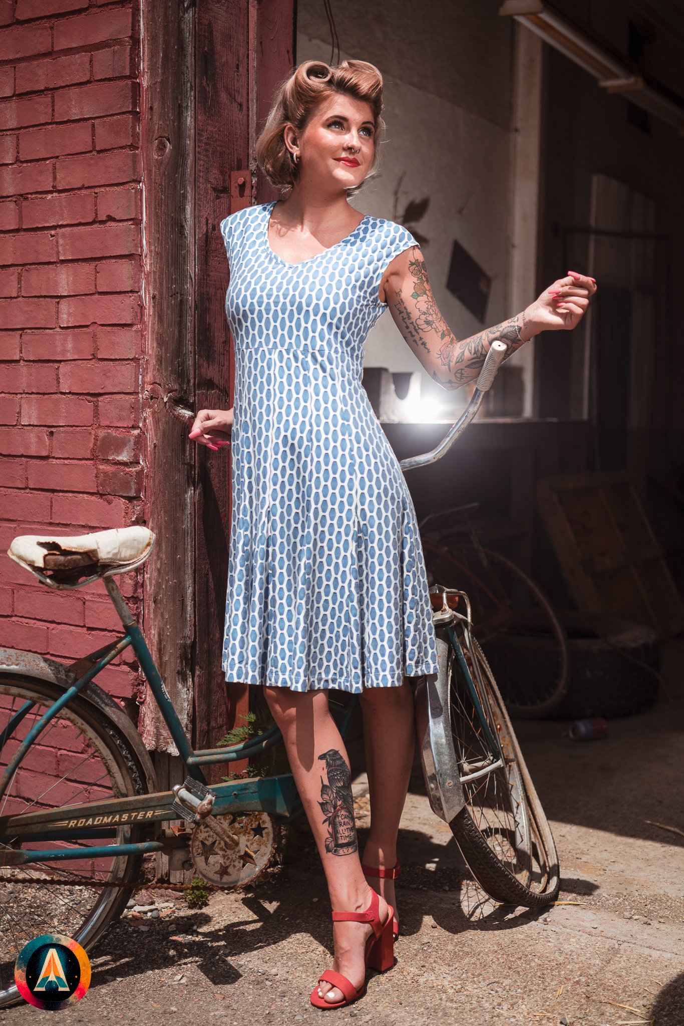 Blonde model courtney france poses in an abandoned shop / laundromat in pinup attire.