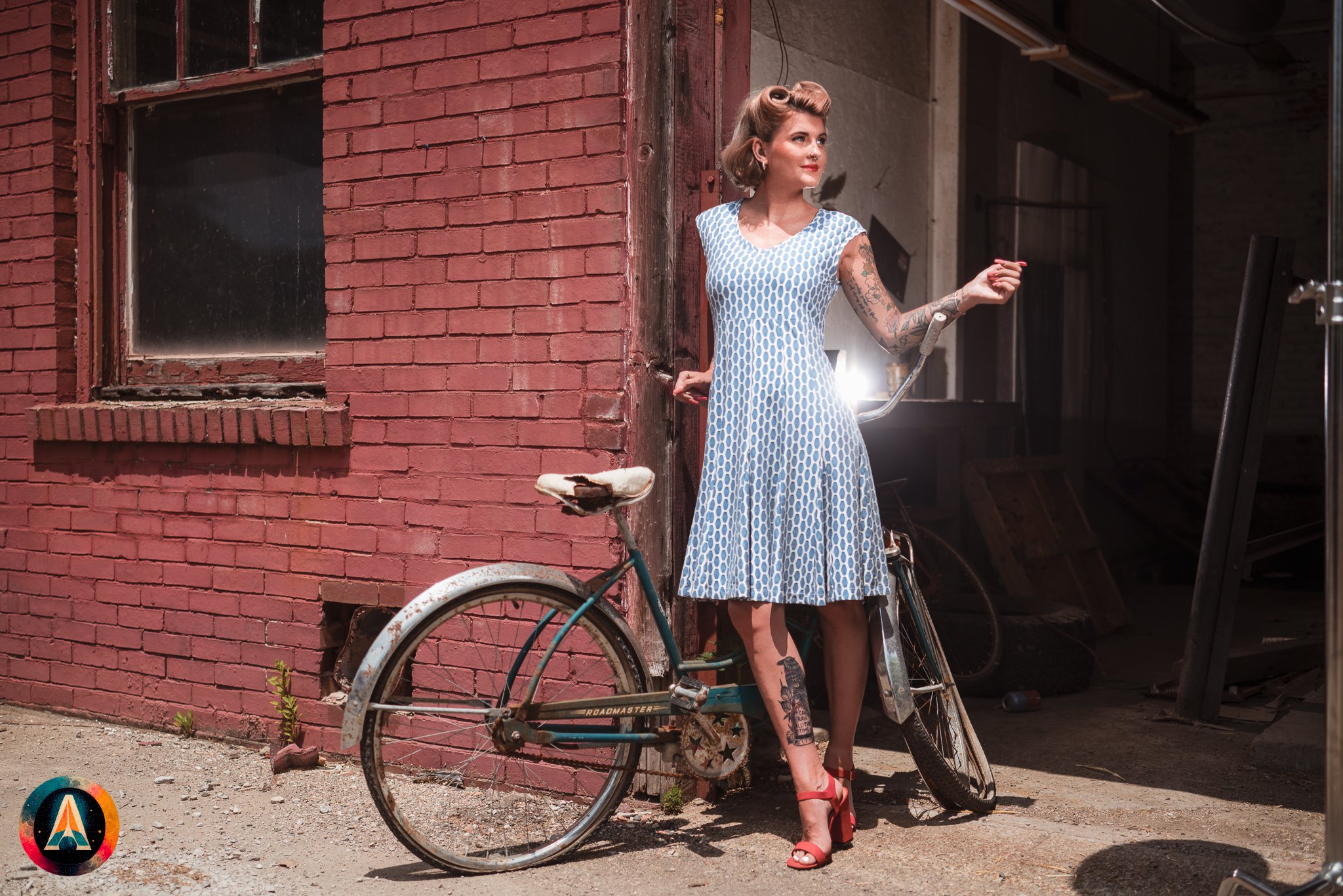 Blonde model courtney france poses in an abandoned shop / laundromat in pinup attire.