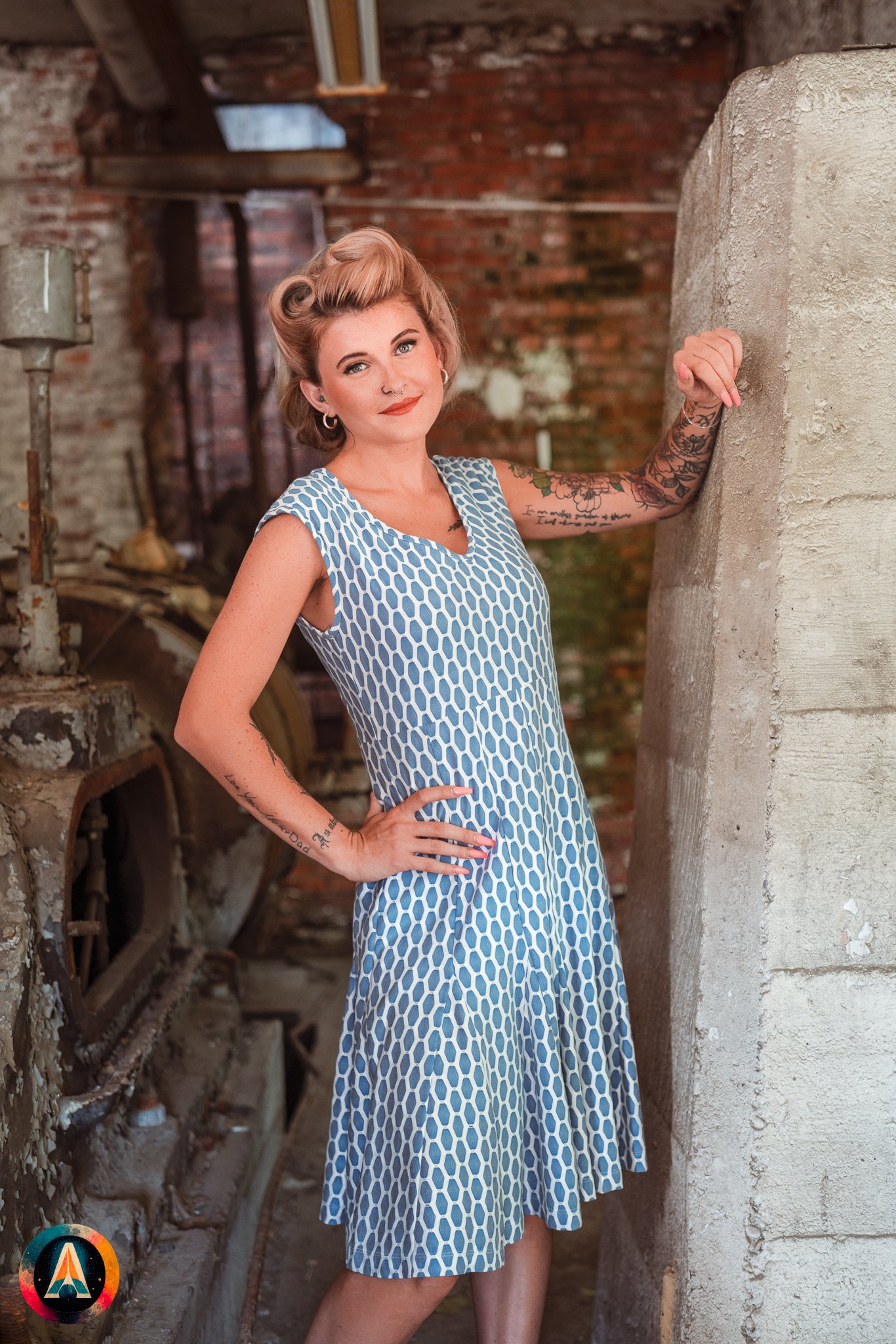 Blonde model courtney france poses in an abandoned shop / laundromat in pinup attire.
