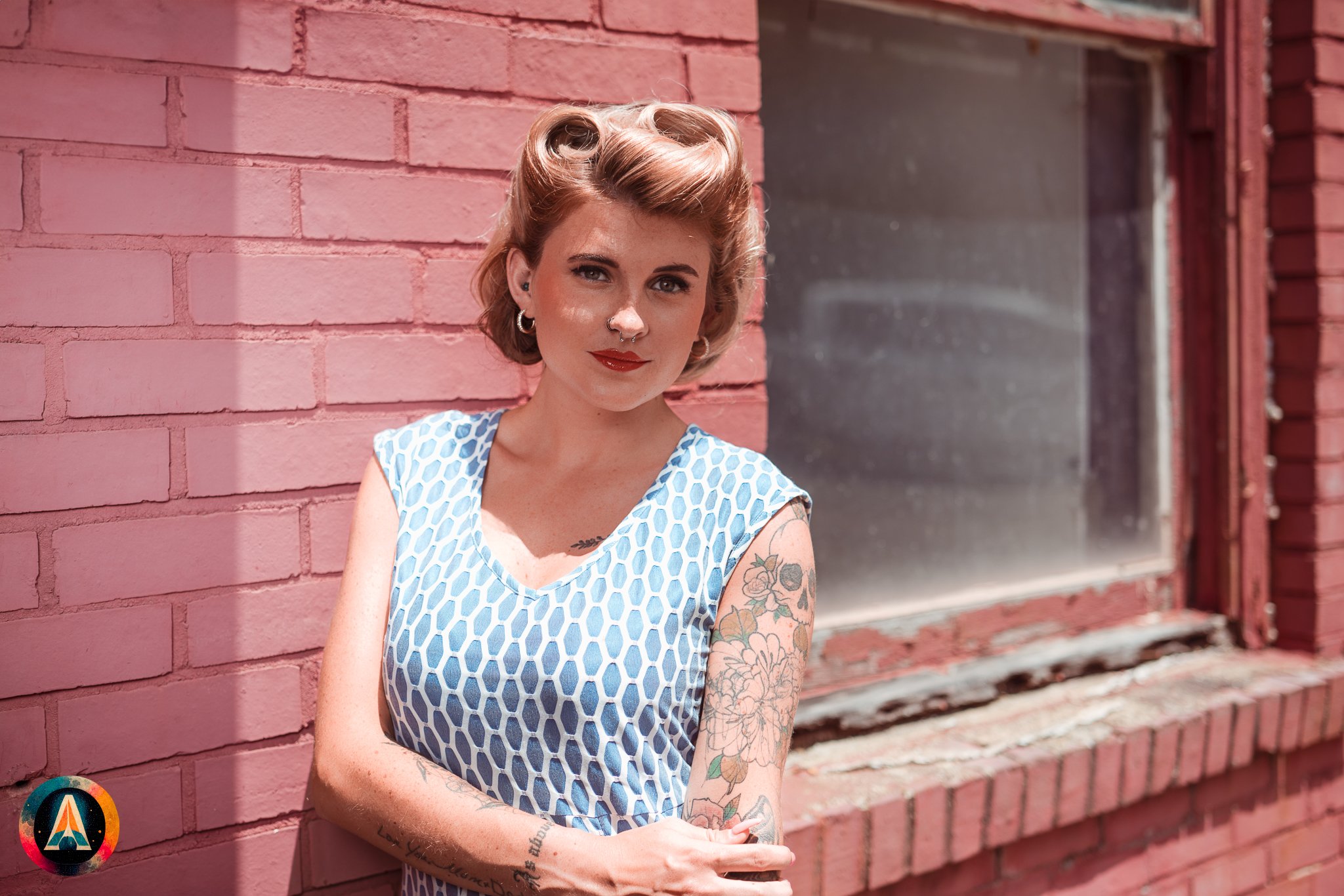 Blonde model courtney france poses in an abandoned shop / laundromat in pinup attire.