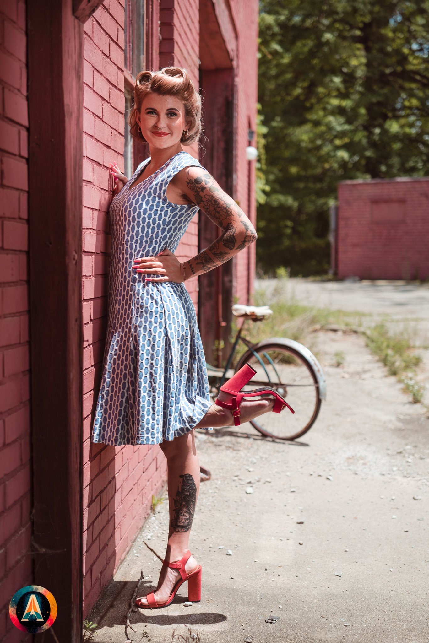 Blonde model courtney france poses in an abandoned shop / laundromat in pinup attire.