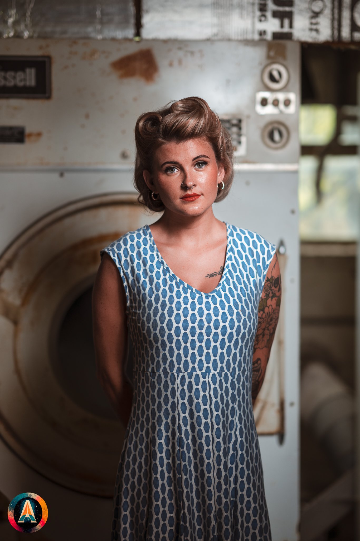 Blonde model courtney france poses in an abandoned shop / laundromat in pinup attire.