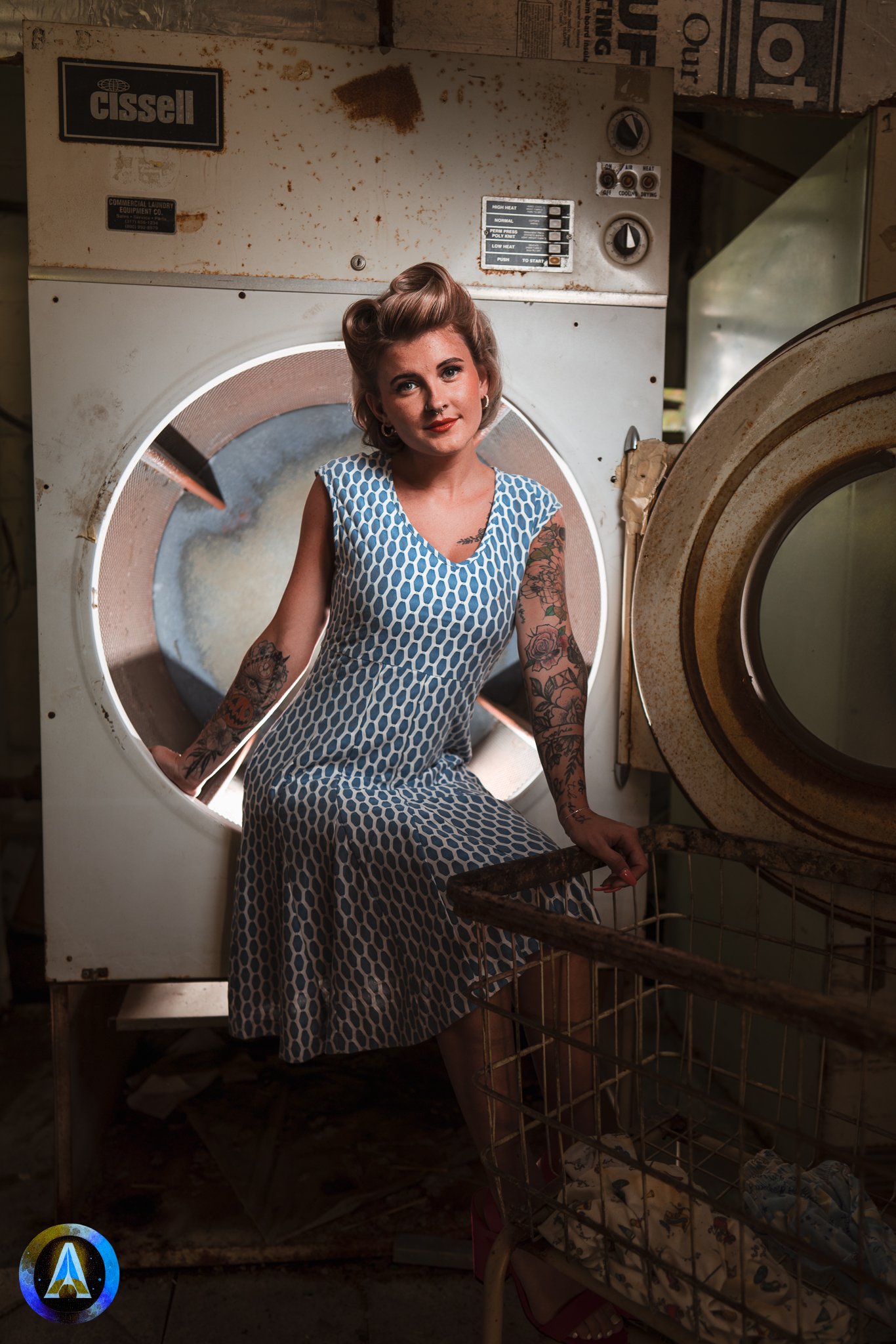 Blonde model courtney france poses in an abandoned shop / laundromat in pinup attire.