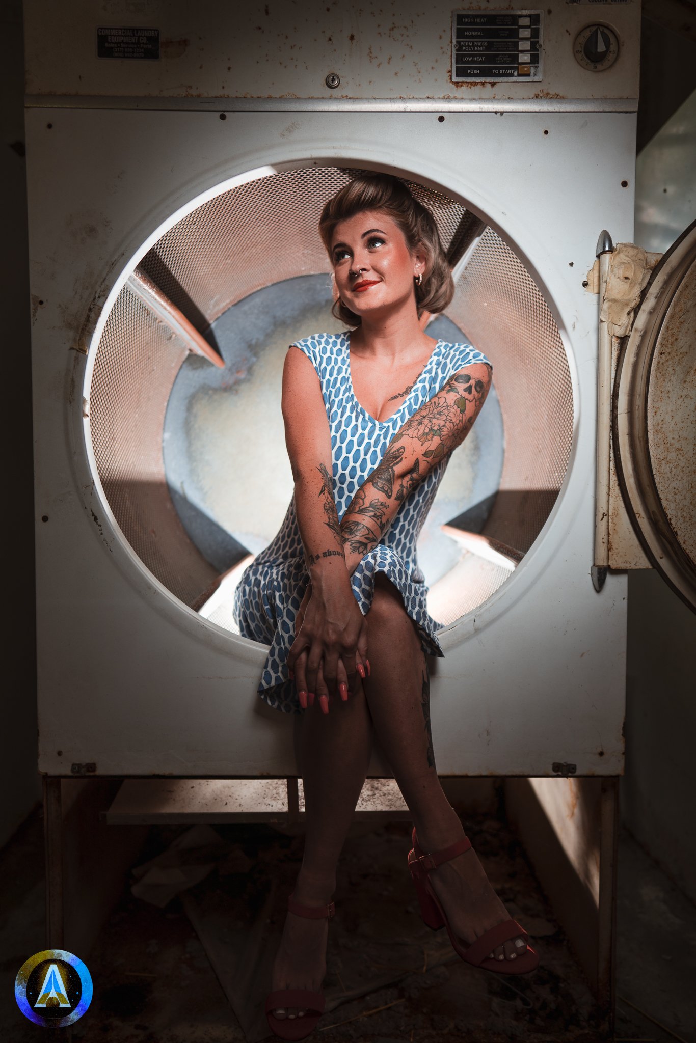 Blonde model courtney france poses in an abandoned shop / laundromat in pinup attire.